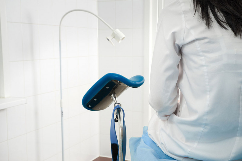 Woman at gynecologist office sitting and waiting for a doctor wi