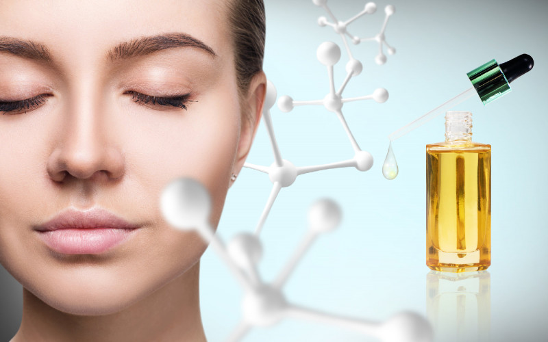 Cosmetic primer oil near woman face with big molecule chain.