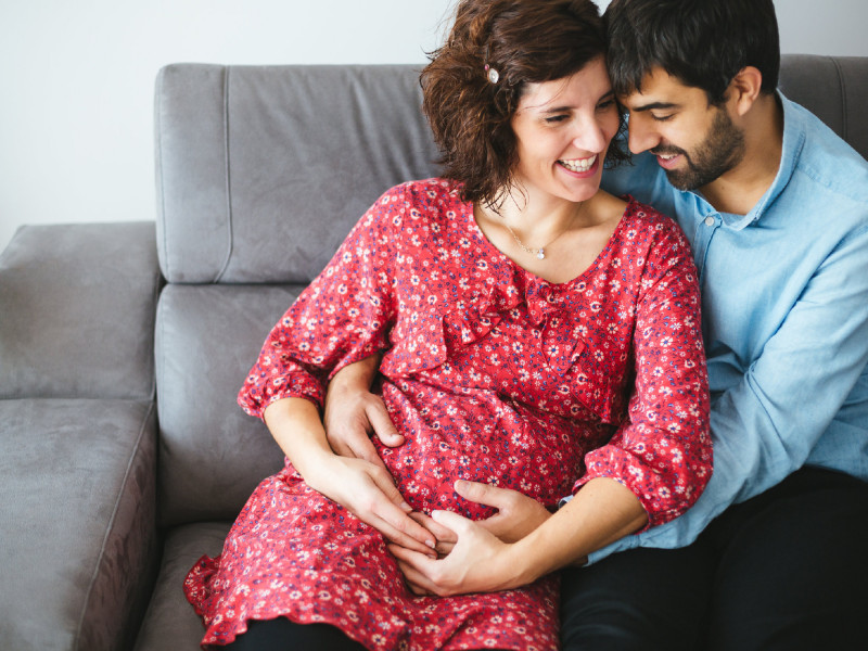 Loving happy pregnant couple at home