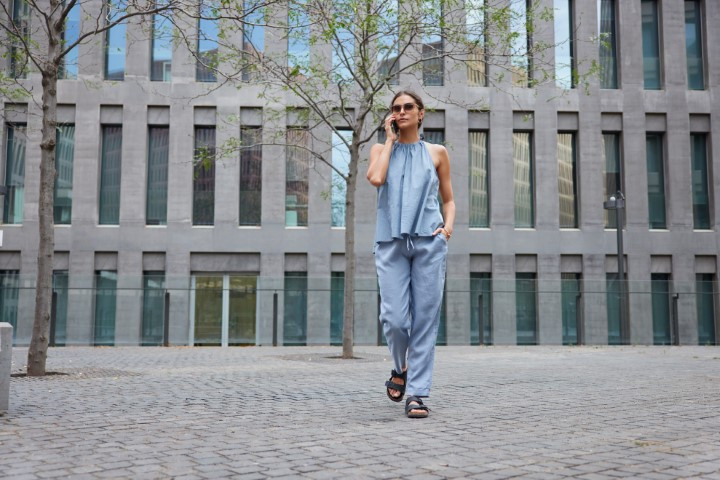 Full length shot of fashionable brunette woman dressed in blue c